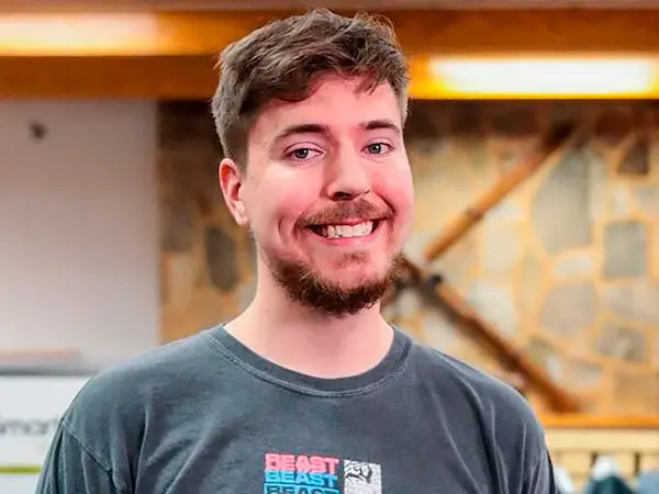 MrBeast smiling indoors with a casual outfit.