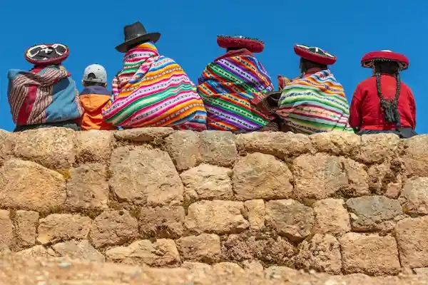 Andean people over a inca wall